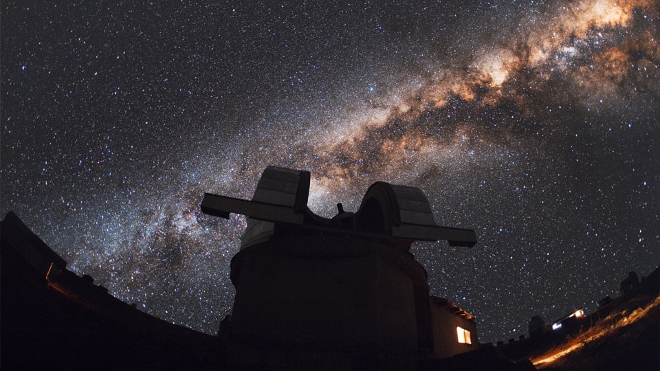 A dark sky with a glittering milky way sprawled across it