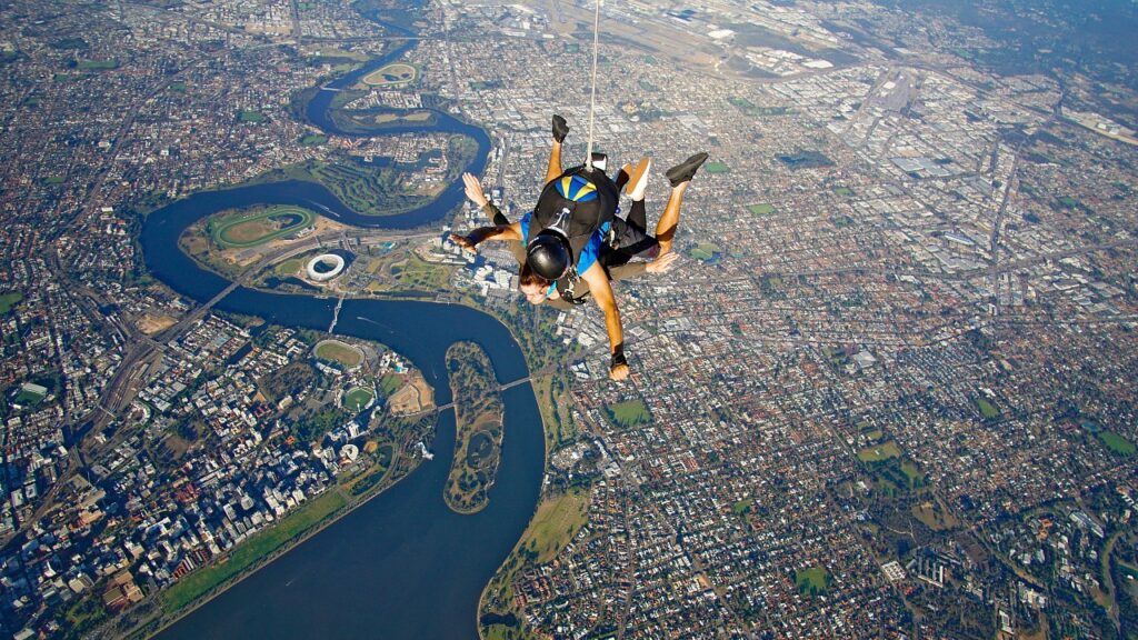 Two people skydiving over the Swan River in Perth